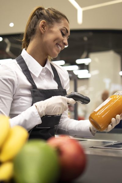 portrait-female-cashier-supermarket-scanning-bar-code-products-sale-min